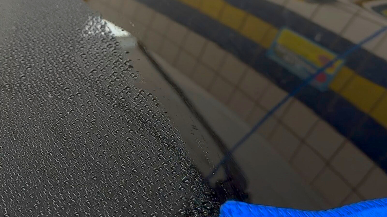 Tight water beads standing on the black hood of a freshly coated RX-8 at a wash bay